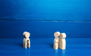 Figurine,With,A,Void,Shape,Of,A,Child,And,Family wooden figurine with a child-shaped void watching figurine parents with child